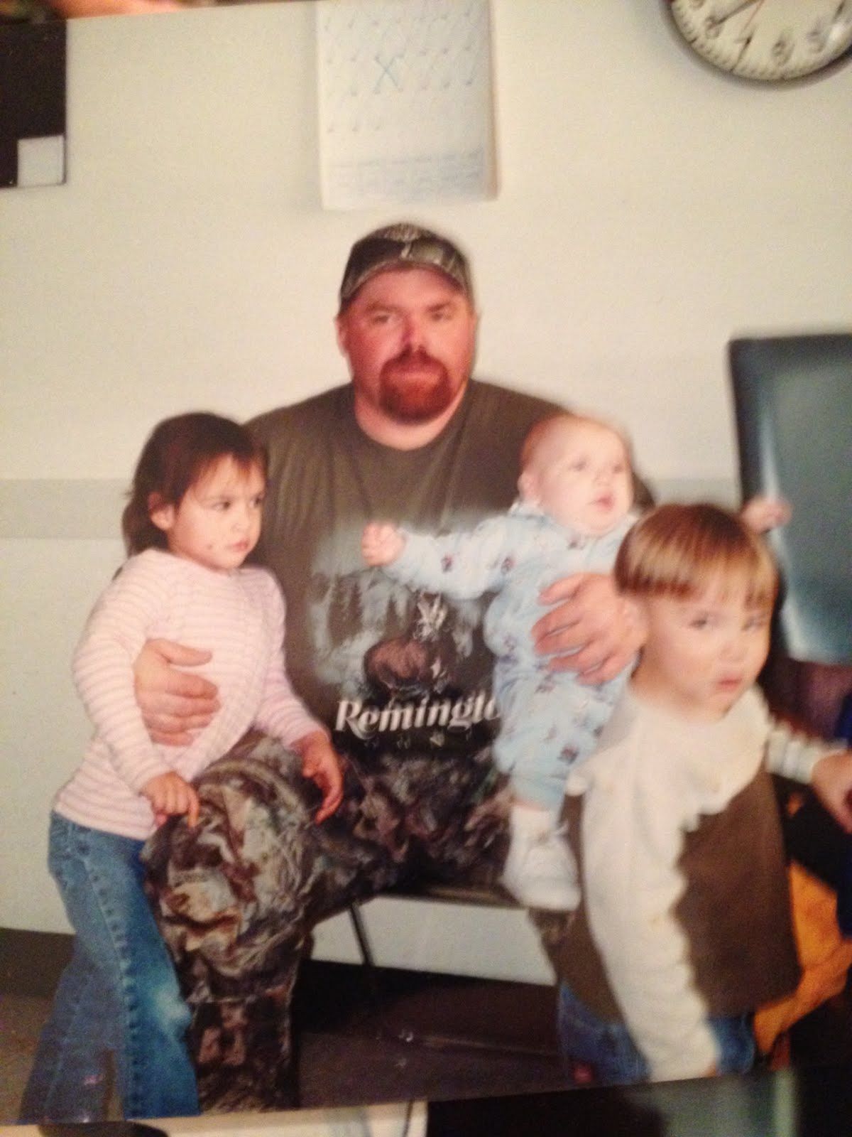 Neil on the sofa with three young children