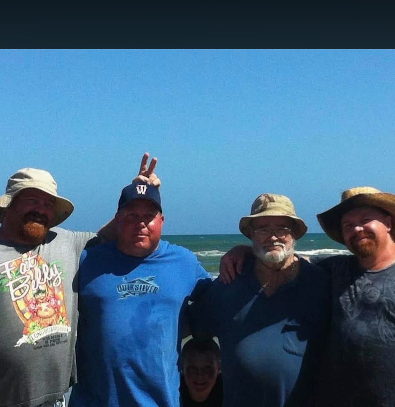 Neil on the beach with two friends