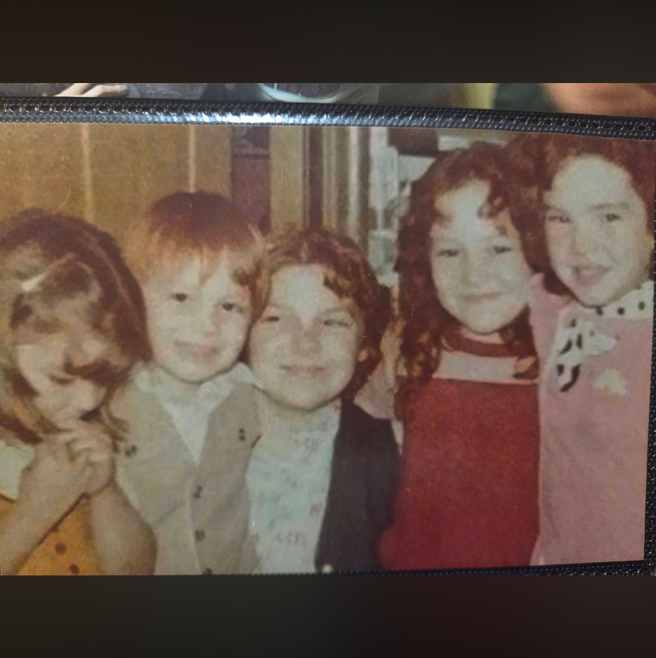 Sepia childhood photo of four young children