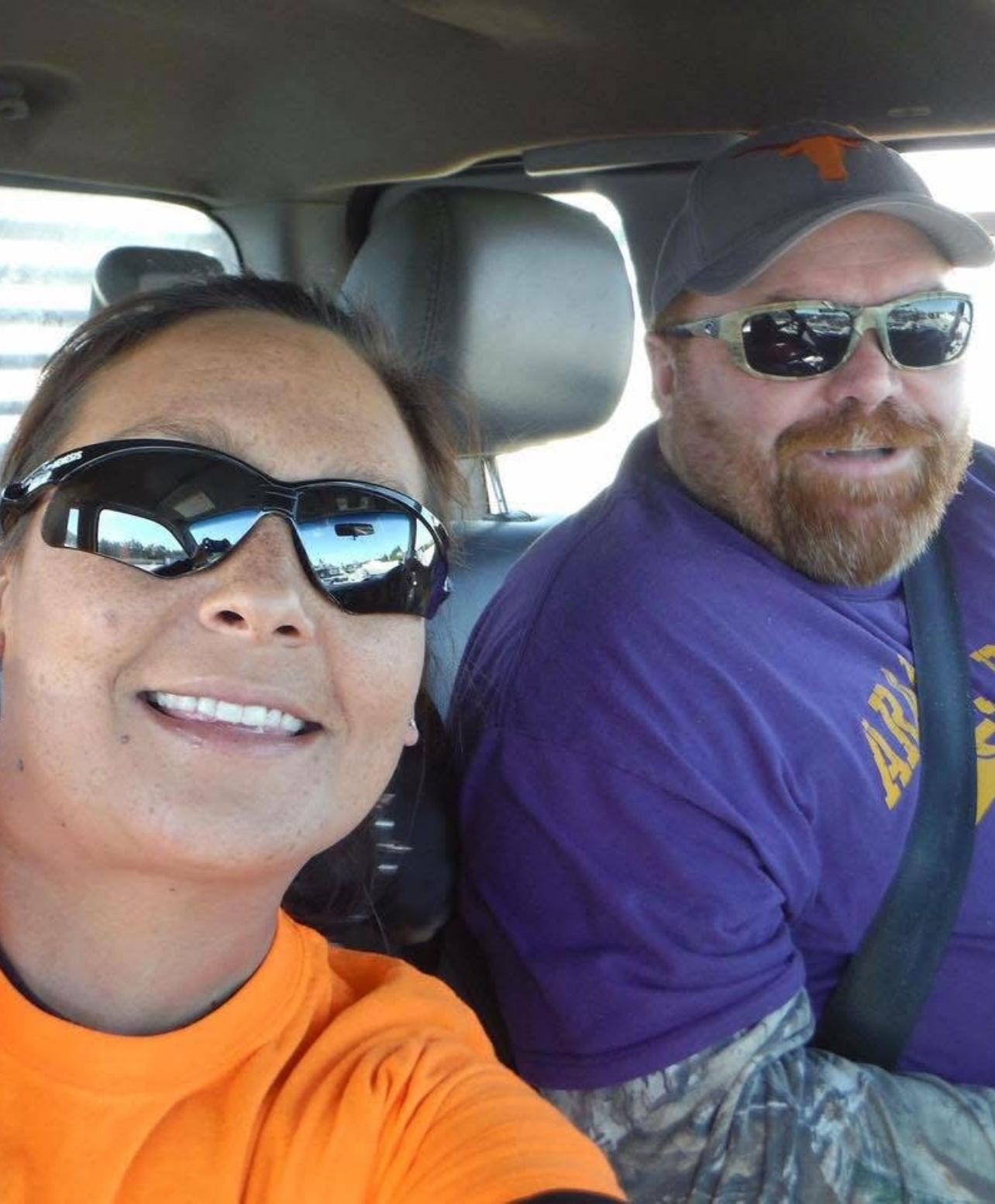 Neil and a woman in the car wearing sunglasses