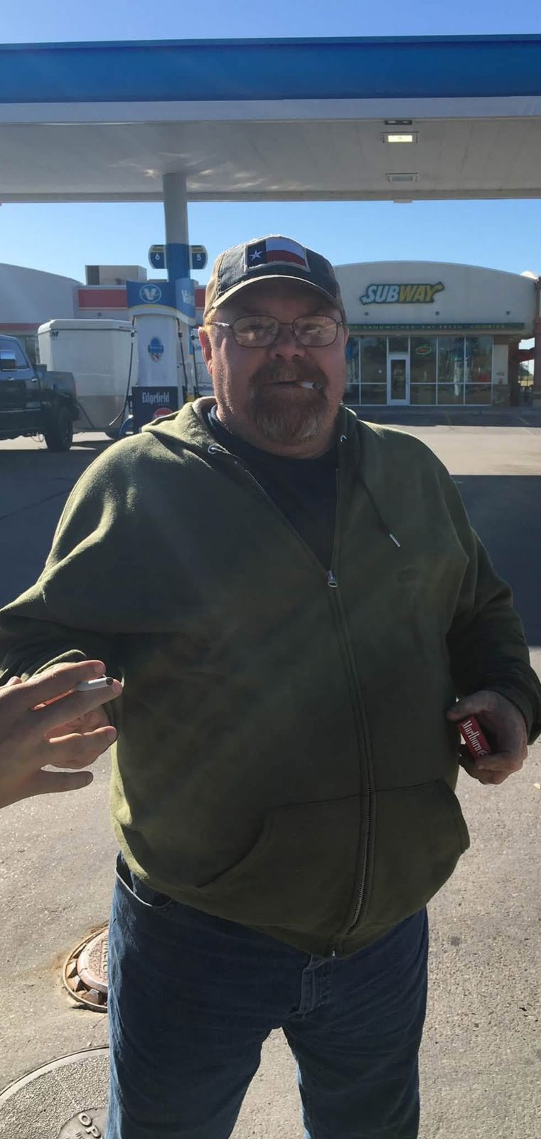 Neil standing outside a gas station at night