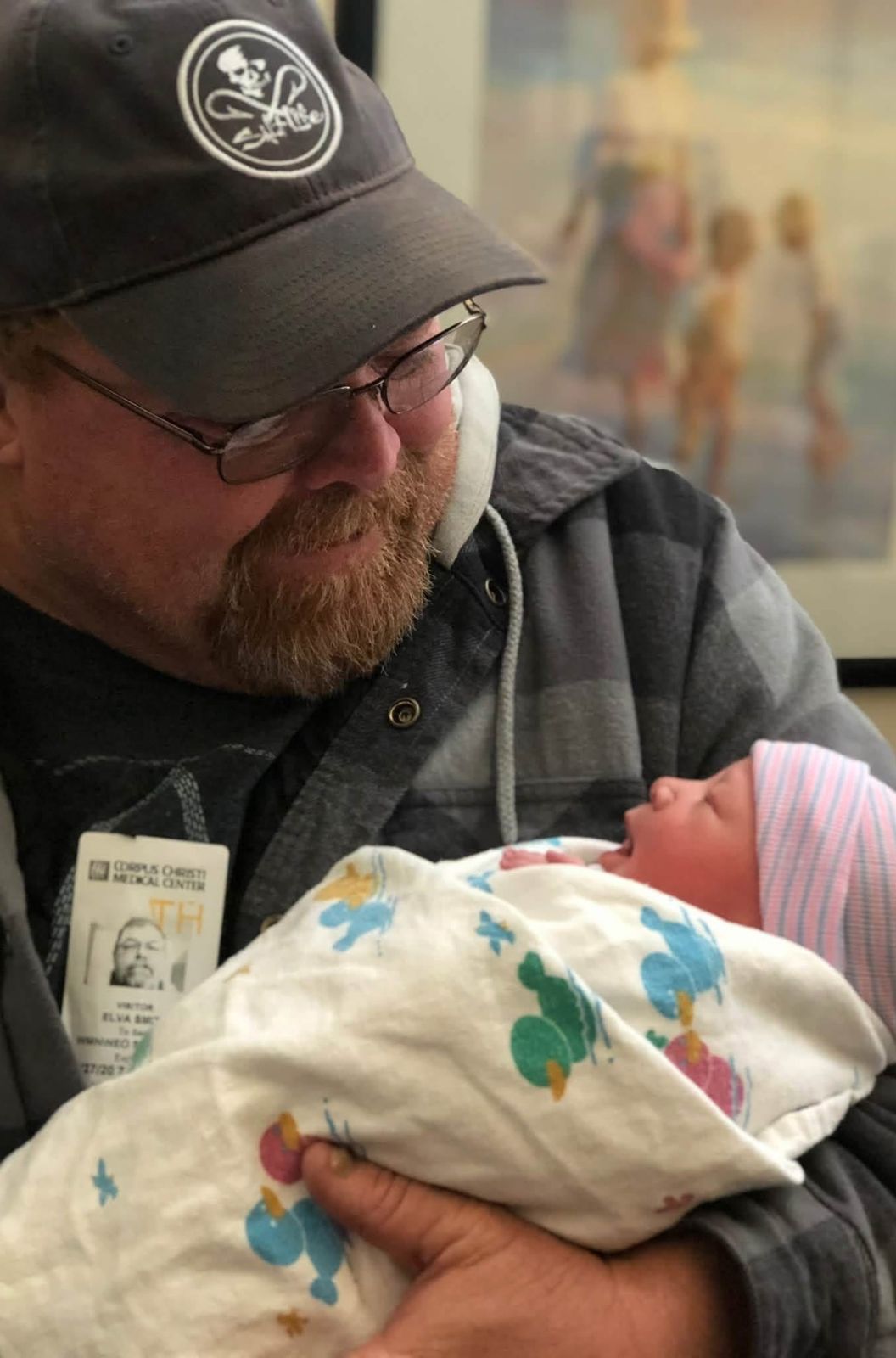 Neil cradling a newborn baby