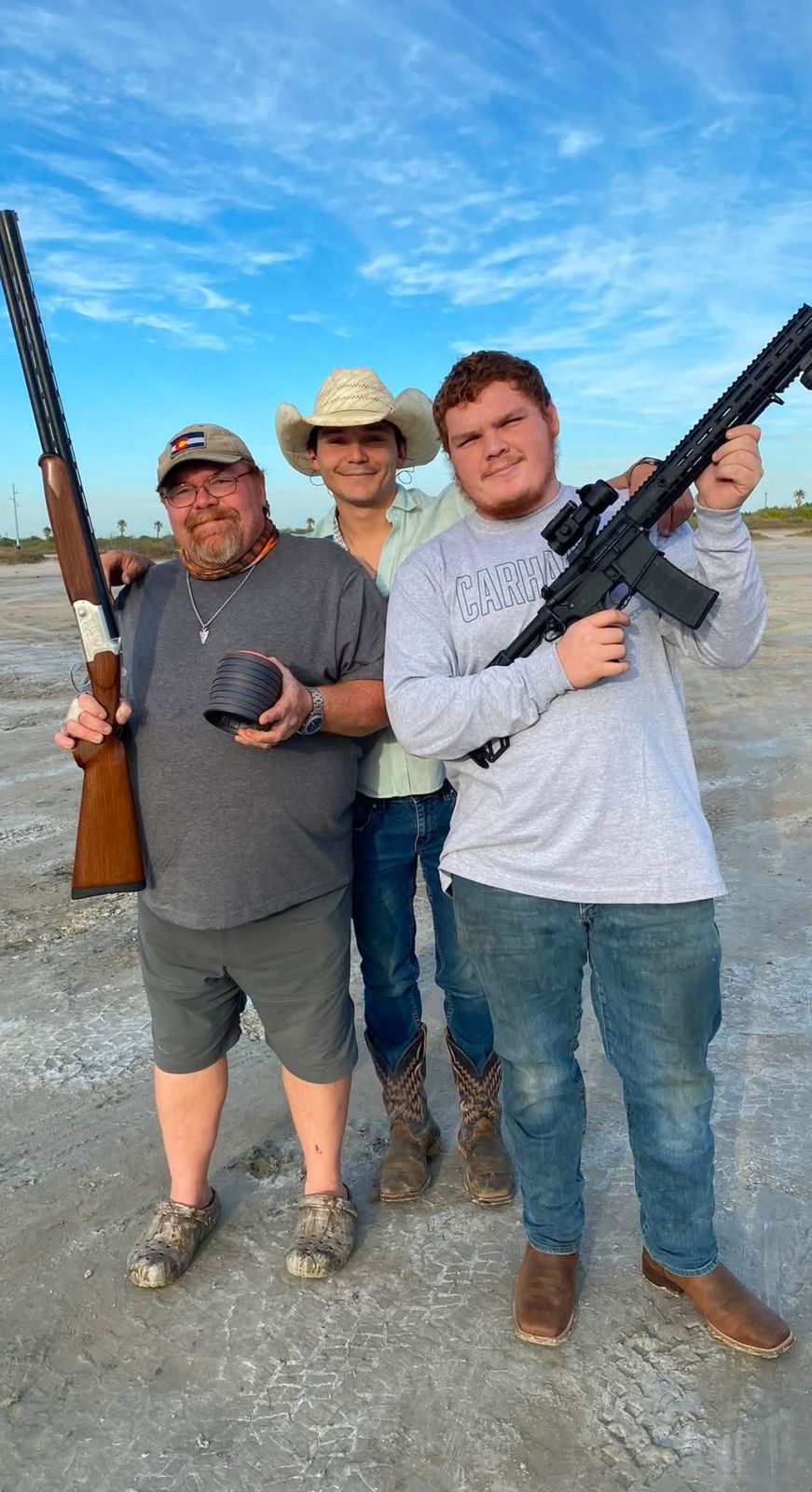 Neil with two younger men after a hunt at dusk