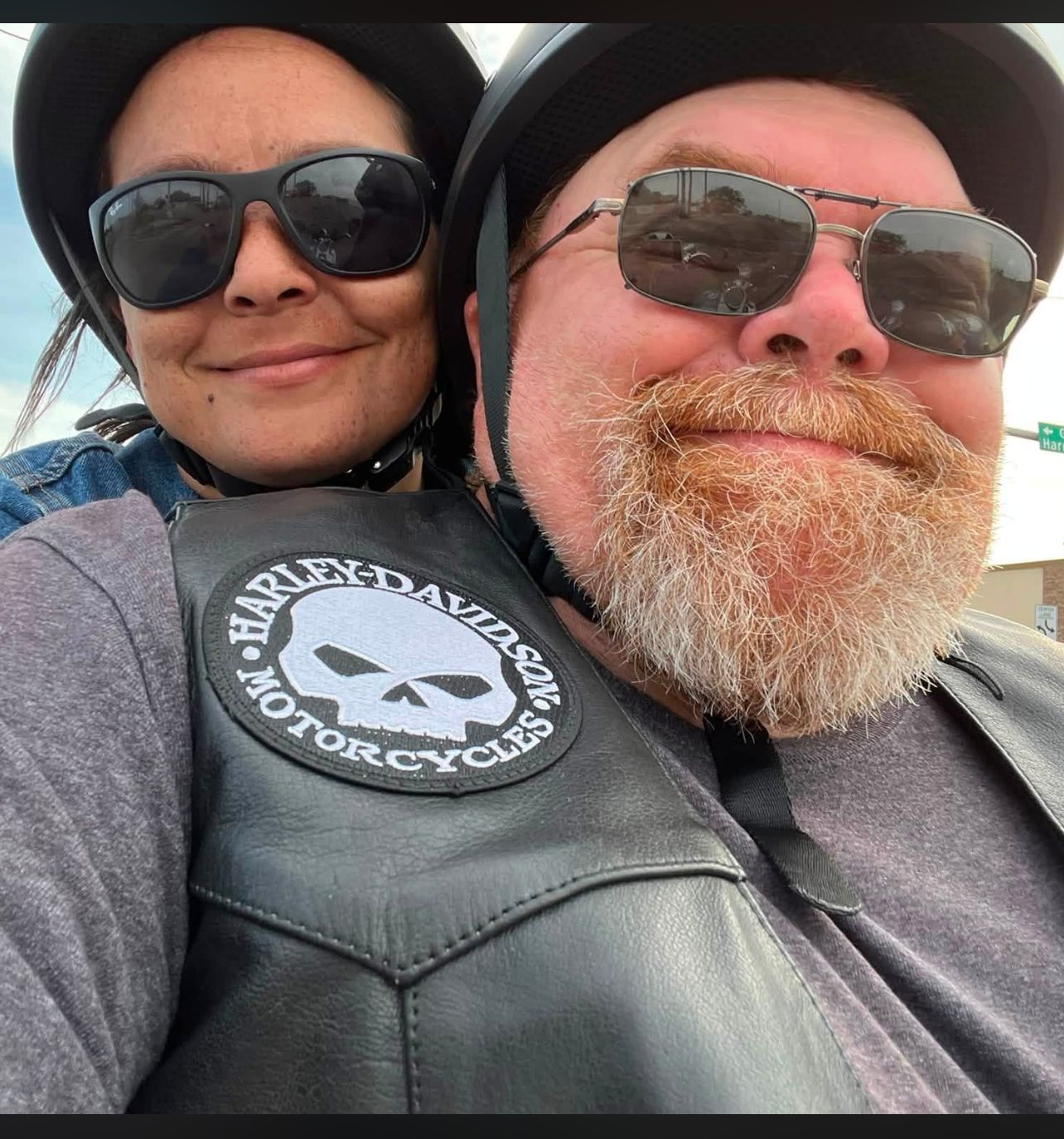 Neil in a Harley vest with Jamie, both smiling