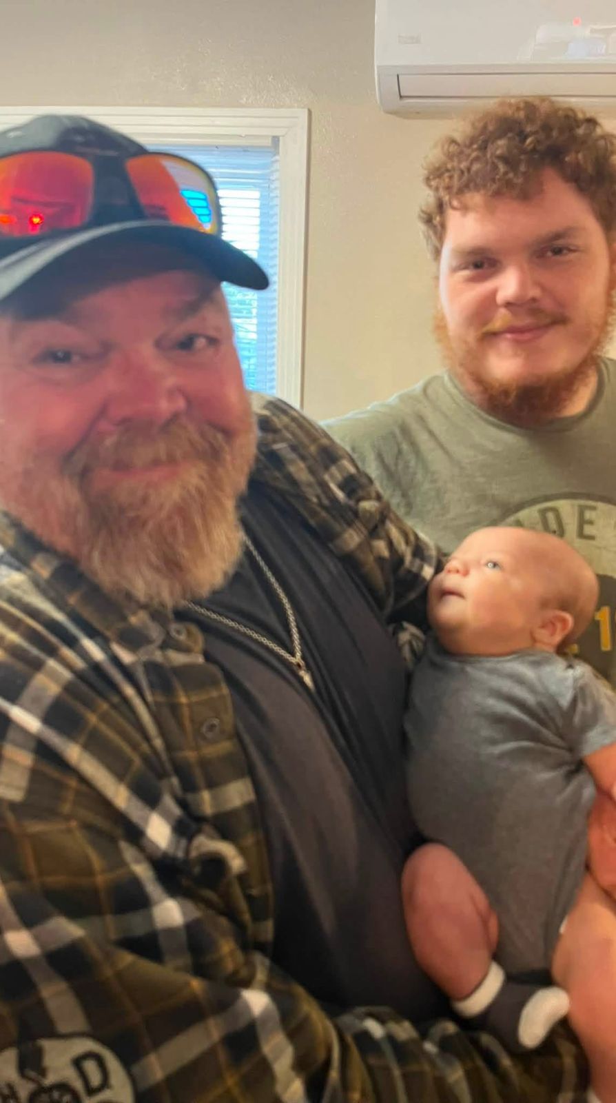 Neil with family and a sleeping baby