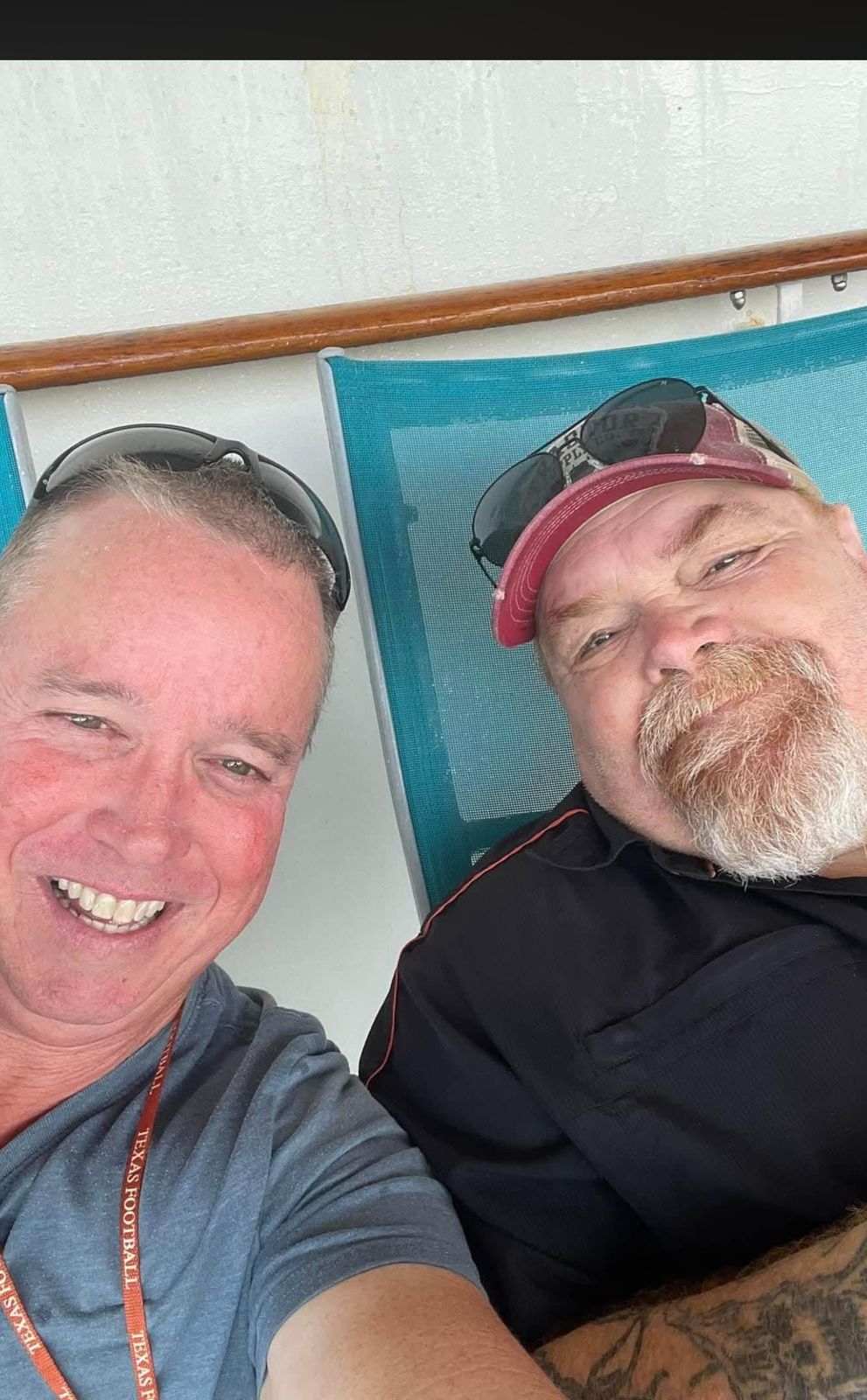 Neil smiling outdoors with a friend