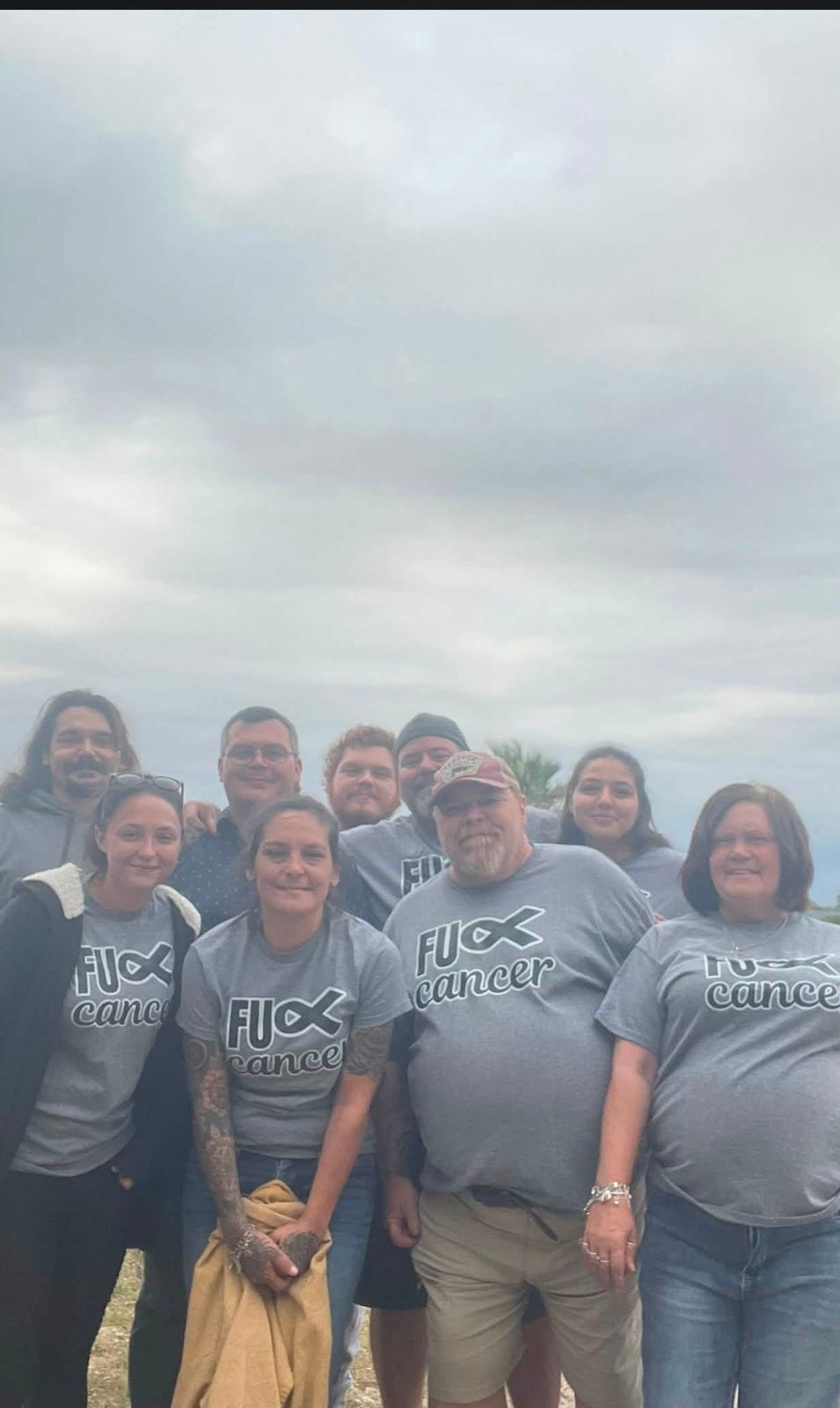 Neil with a group in matching Team shirts