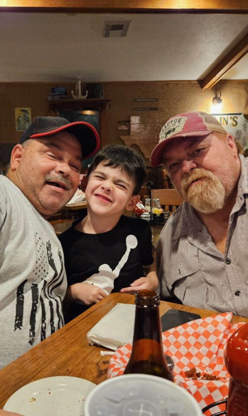 Neil at a restaurant with a young boy and an older man