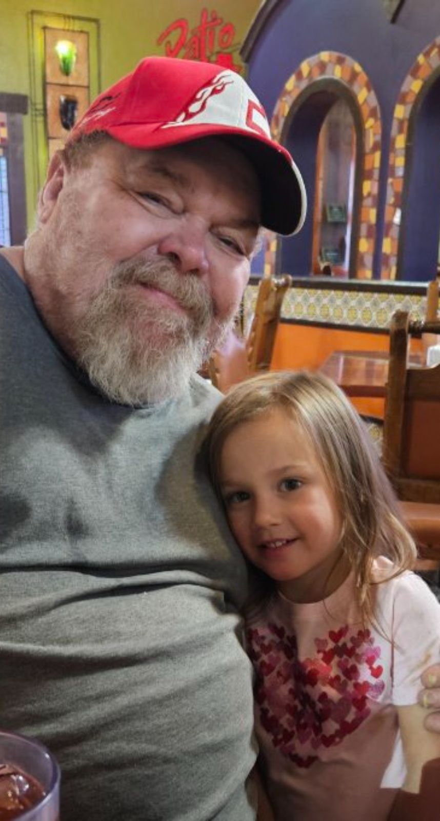Neil smiling next to a young girl with a floral headband