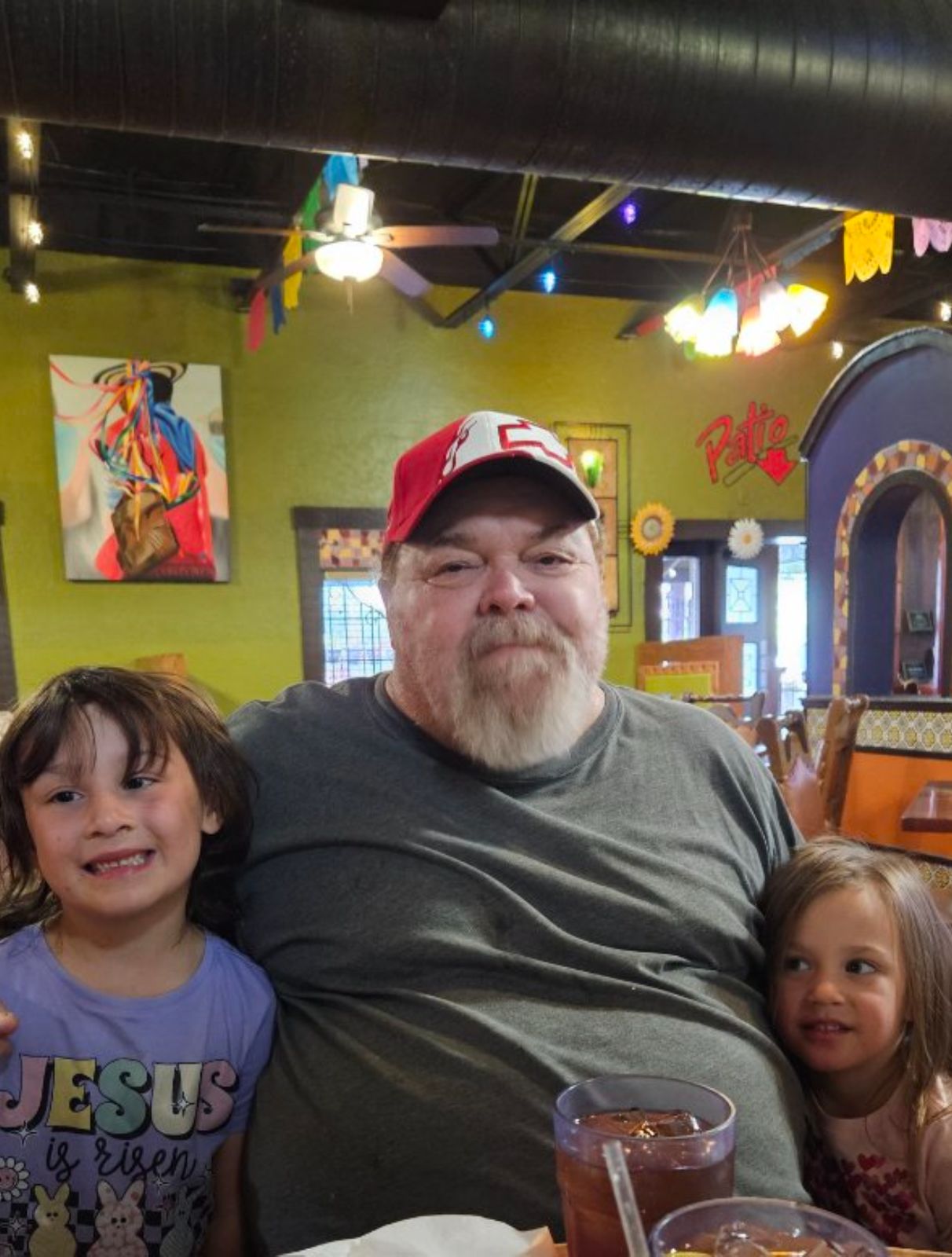 Neil at a restaurant with two grandchildren