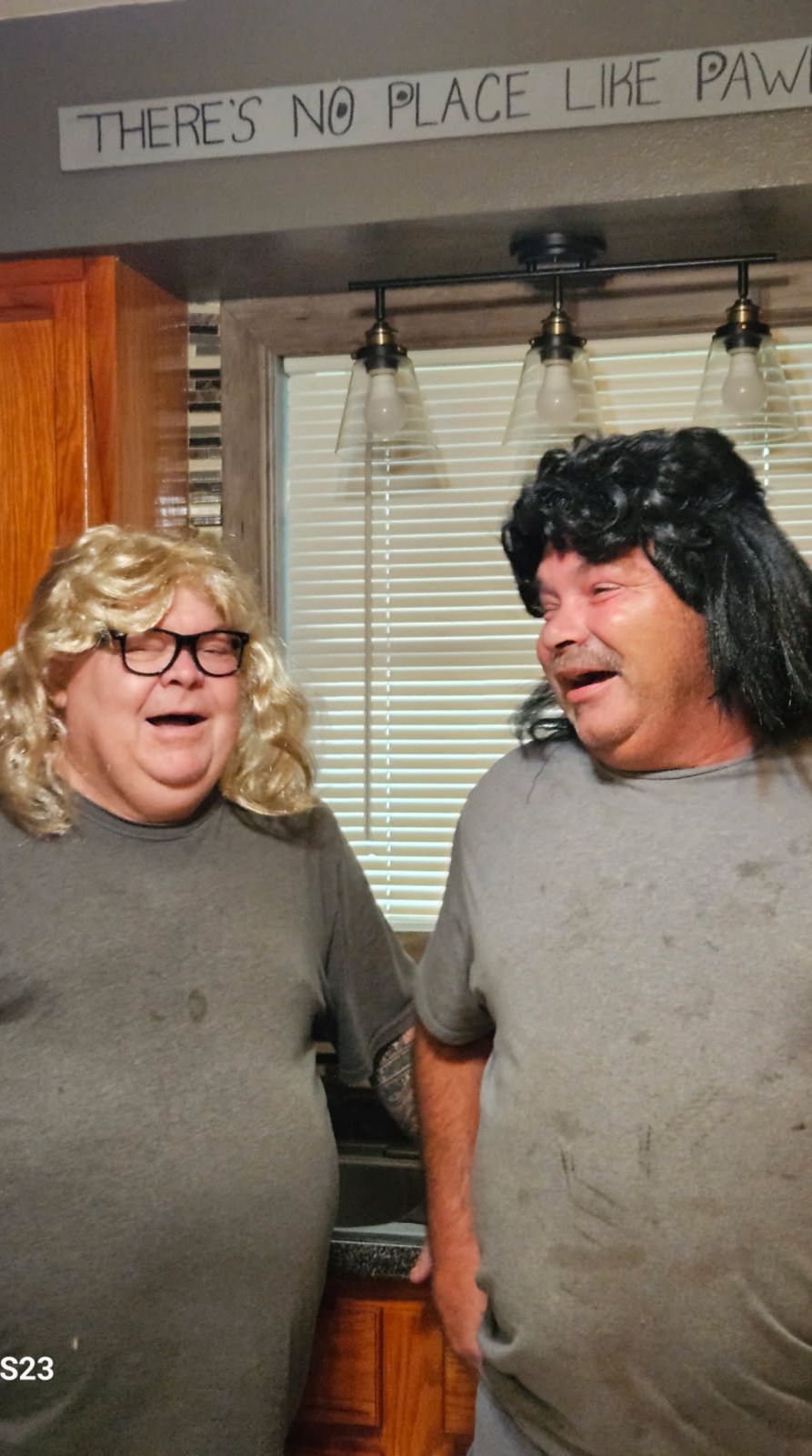 Neil in a curly wig beside a friend in a blonde wig