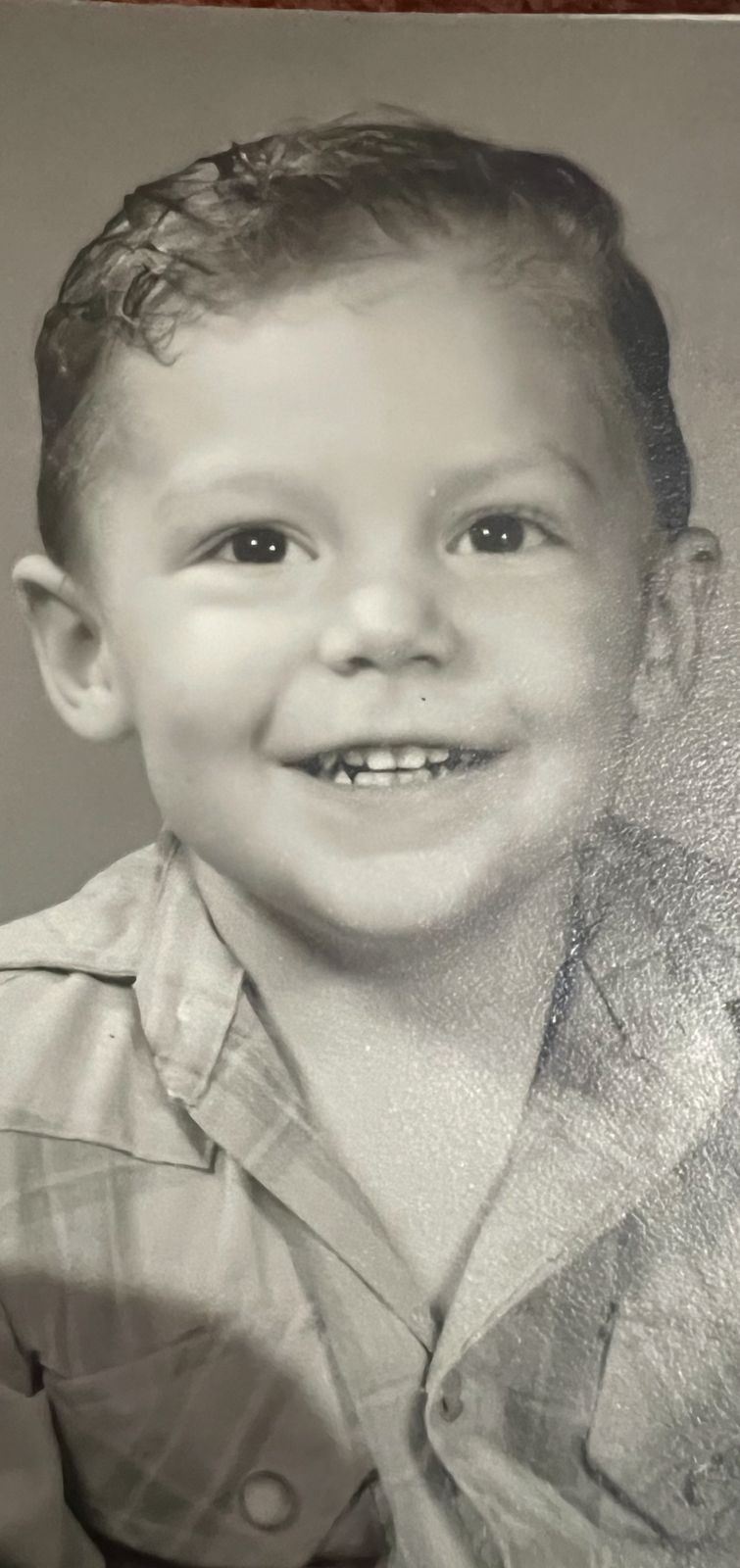 Black-and-white portrait of Neil as a young boy