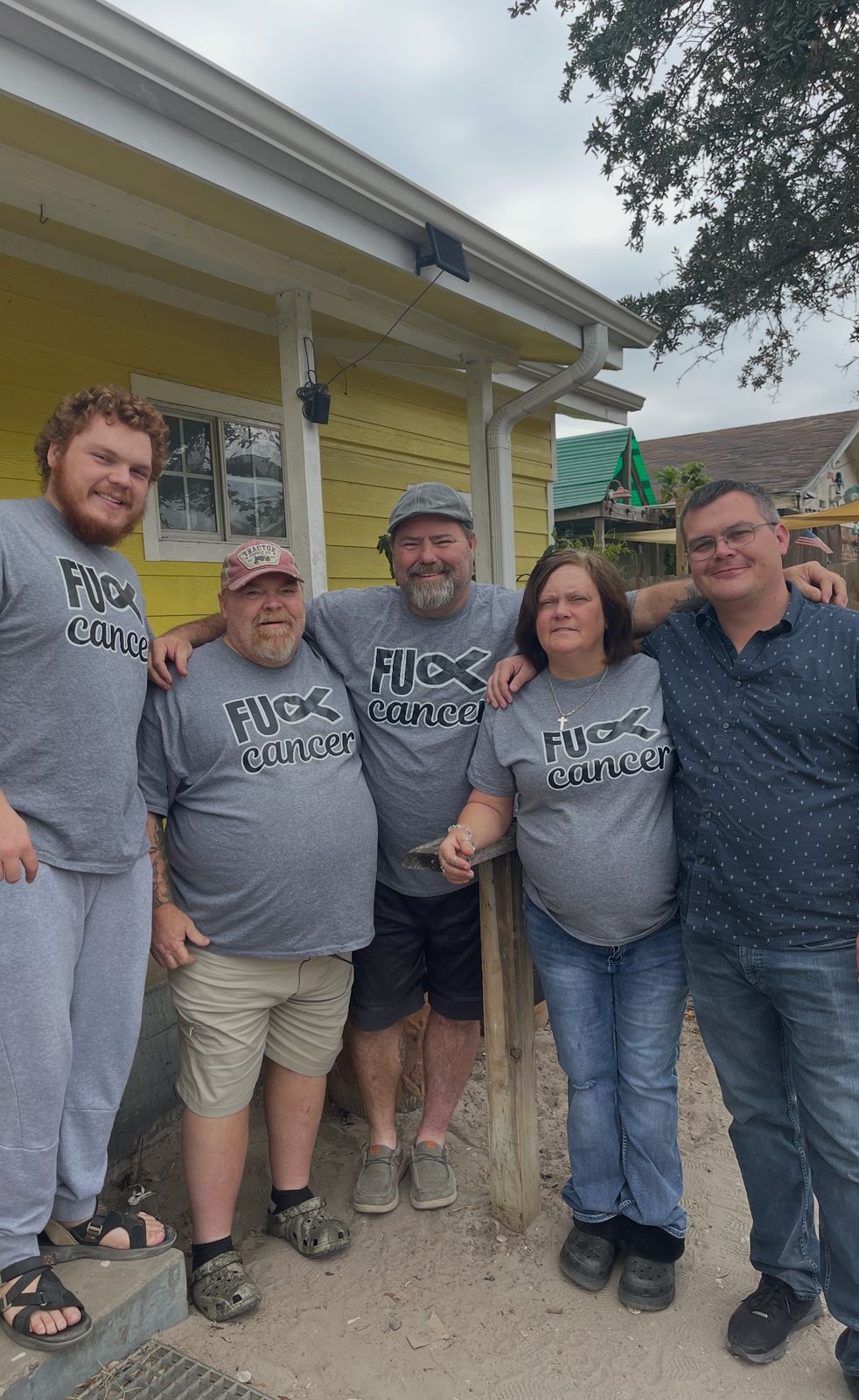 Neil with a group in matching Team shirts outdoors